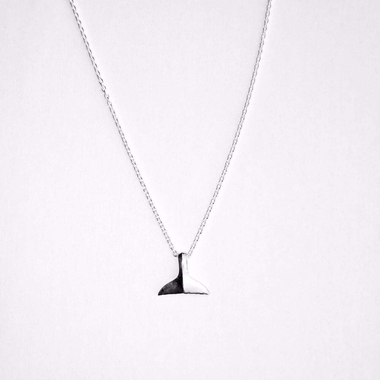 Delicate mini whale tail necklace